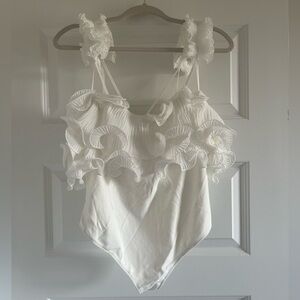 NWT white ruffle size large free people bodysuit. Never worn